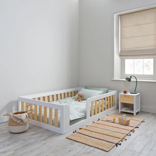What is the difference between a floor bed and a standard toddler bed for a 2-year-old?