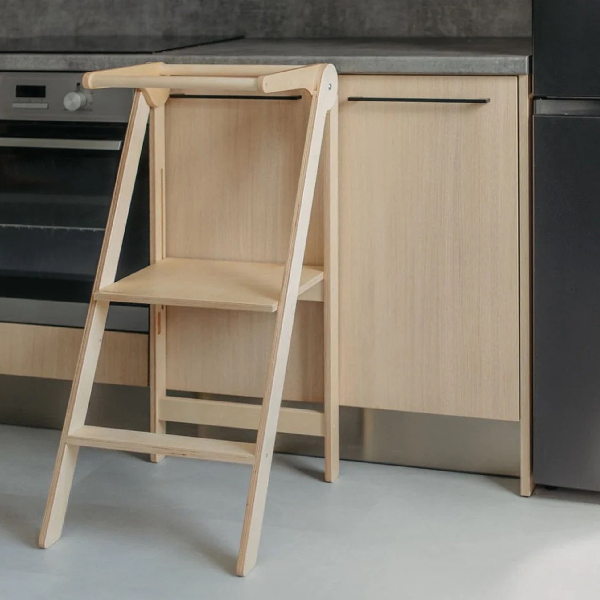 Foldable toddler tower unfolded and ready for use, showcasing natural wood finish and practical design by Roomix
