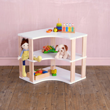 Wide shot of Montessori corner shelves filled with educational toys and books in a cozy kids' learning space
